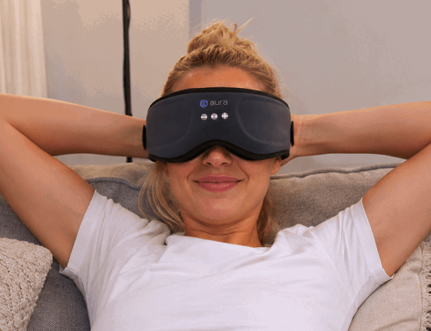 Woman relaxing while wearing the Aura Sleep Mask