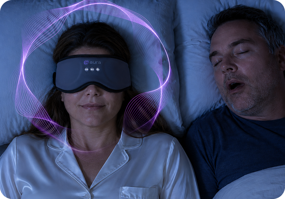 Woman sleeping peacefully in the AURA mask beside her snoring partner