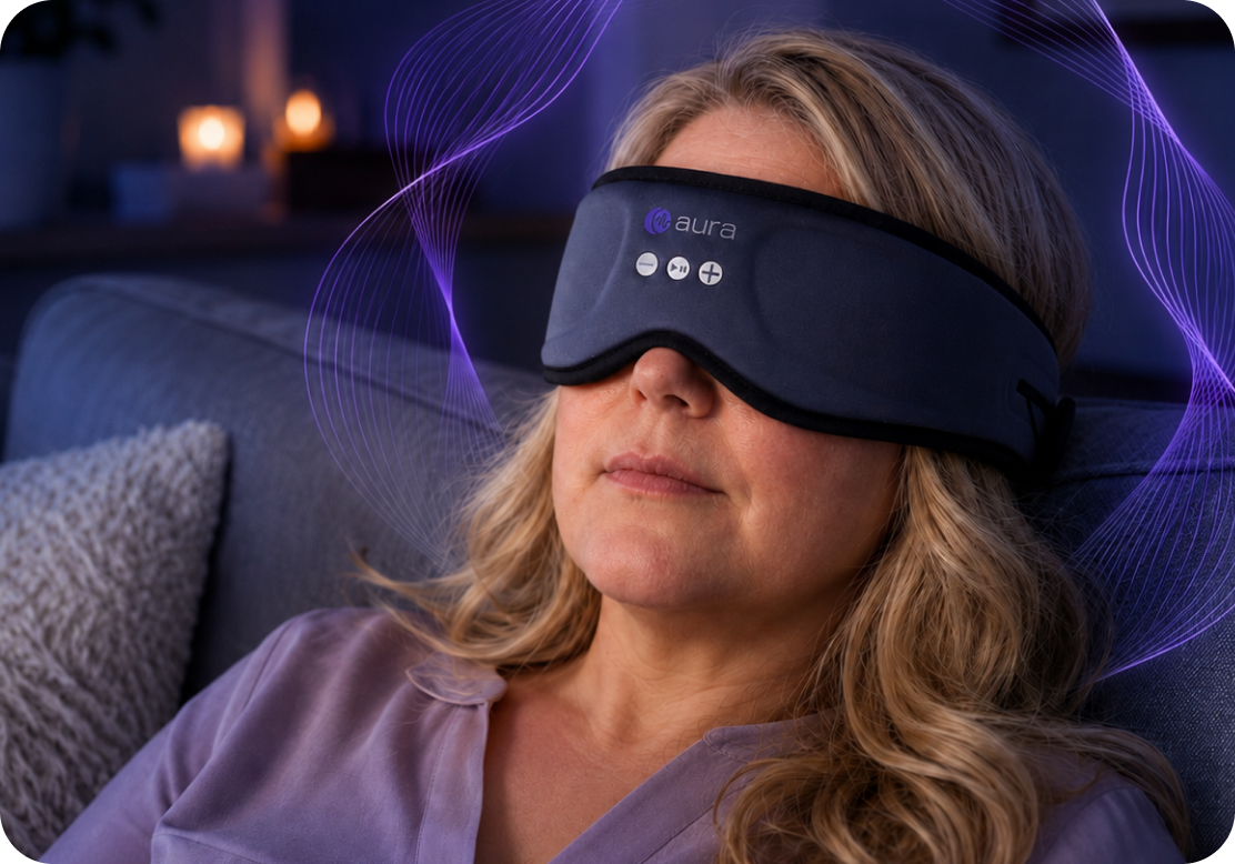 Woman relaxing on a couch wearing the AURA mask