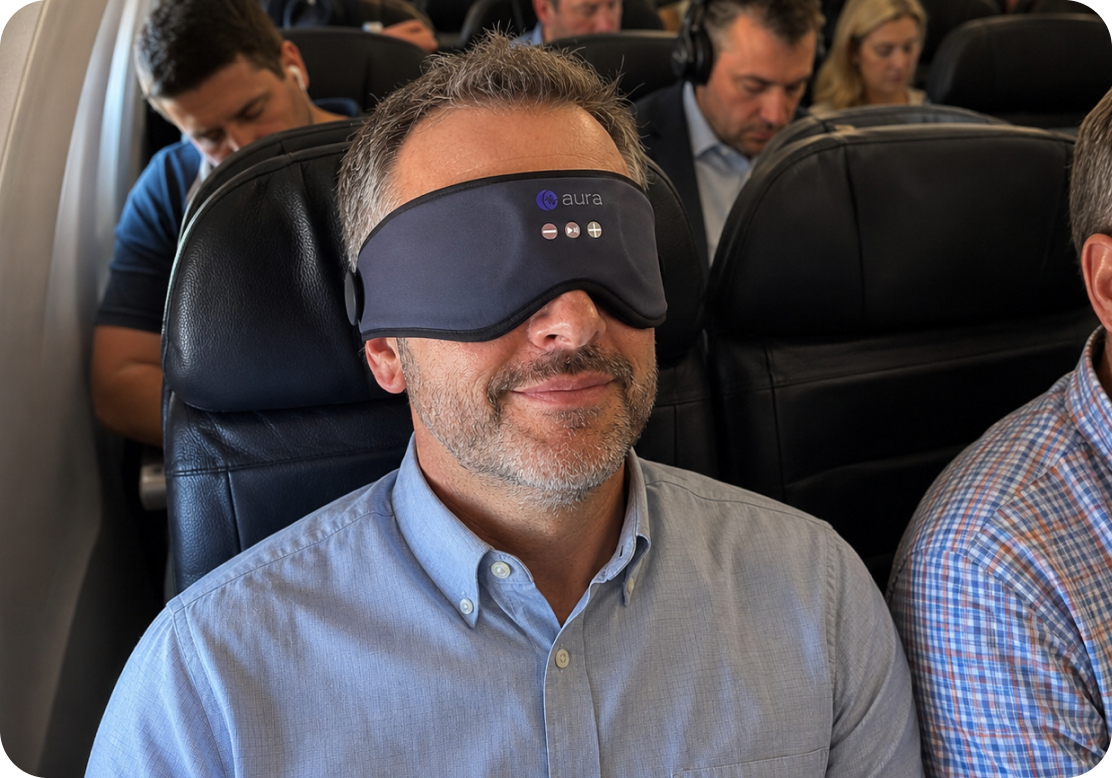 Man sleeping on an airplane wearing the AURA mask