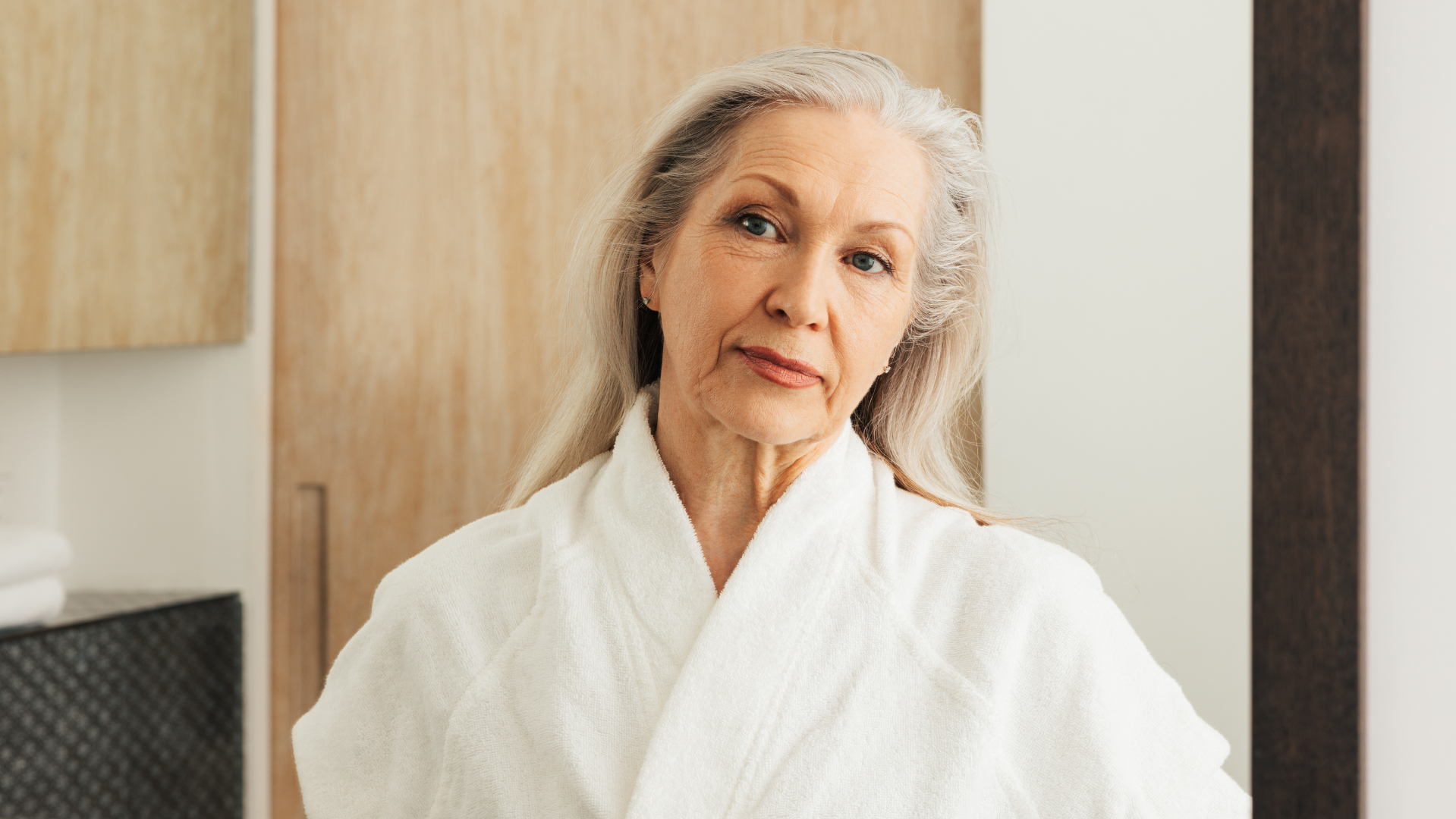 Person looking in mirror during midlife