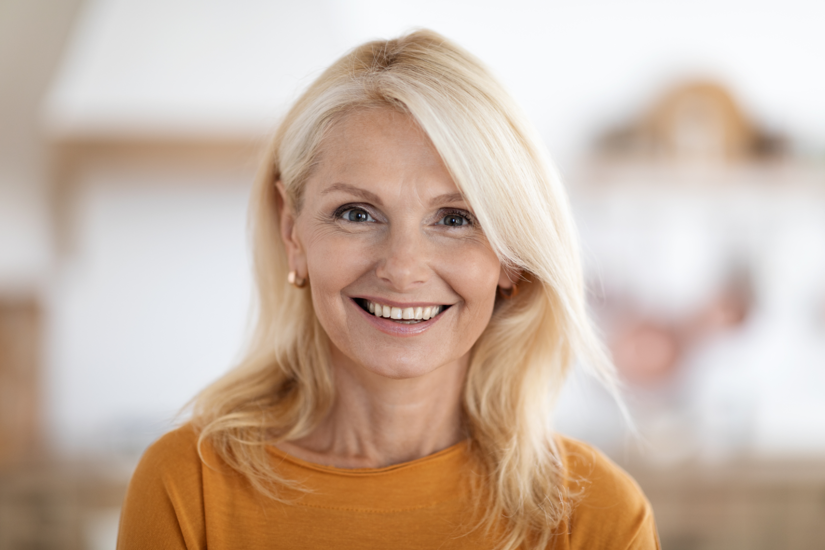 Smiling woman learning about hormone replacement therapy