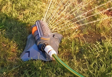 Garden Maestros Pro Sprinkler watering a green lawn