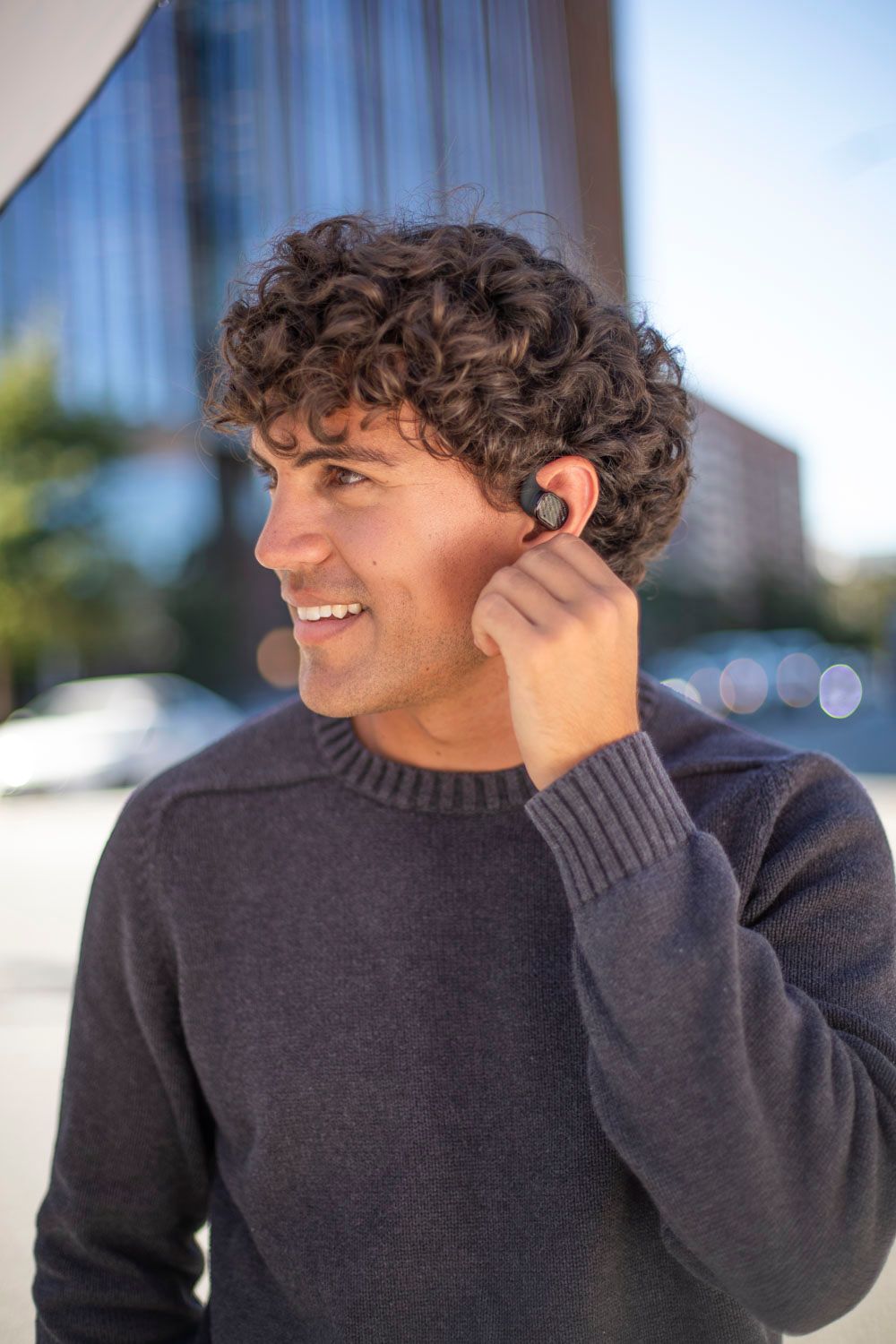 Customer wearing Groovz open-ear headphones outdoors