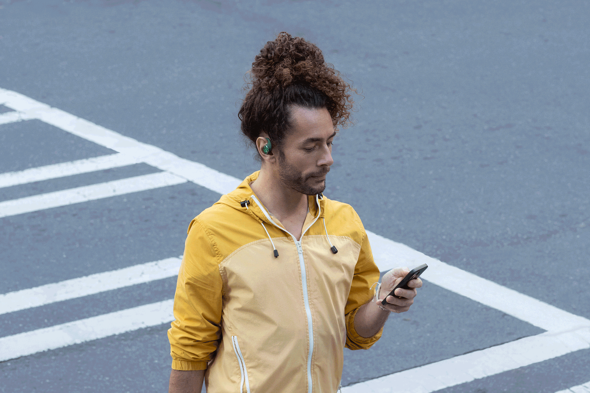 Customer in a yellow jacket wearing Groovz headphones