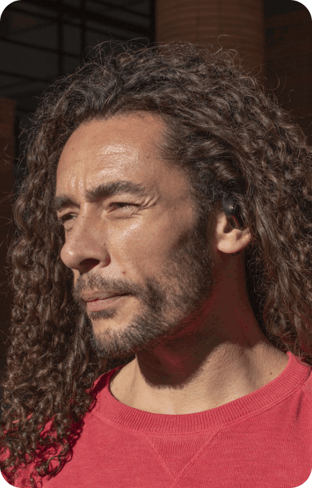Customer with curly hair wearing Groovz headphones