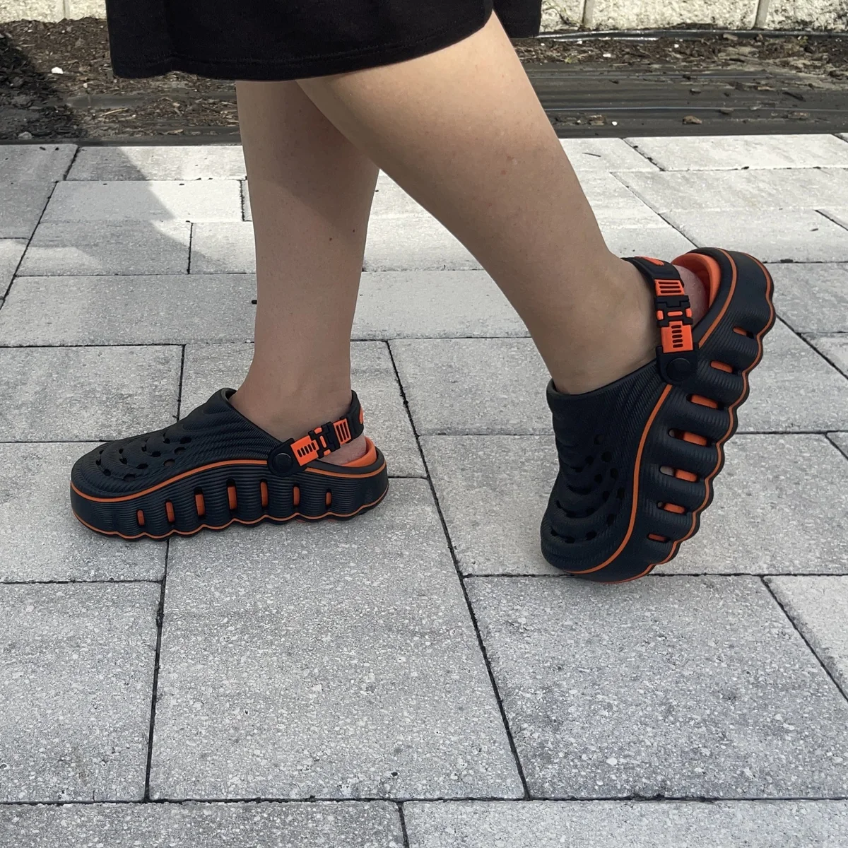 Restore Clogs in Black Ember, worn walking outdoors