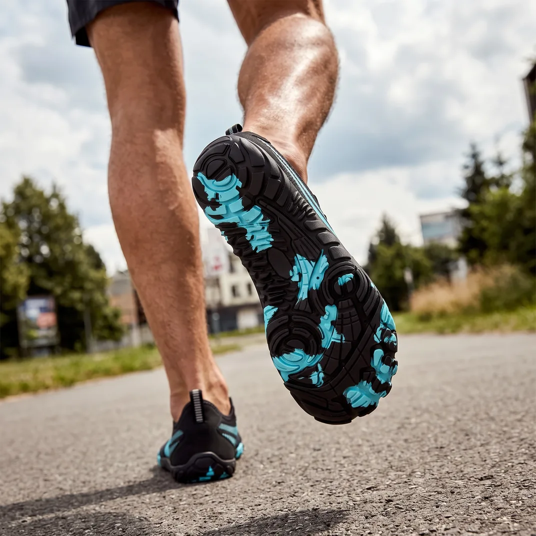 The patterned Ascend sole, seen mid-stride on a road