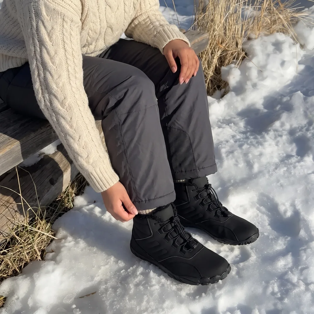 A woman wearing Grounded Footwear® Limitless boots in the snow