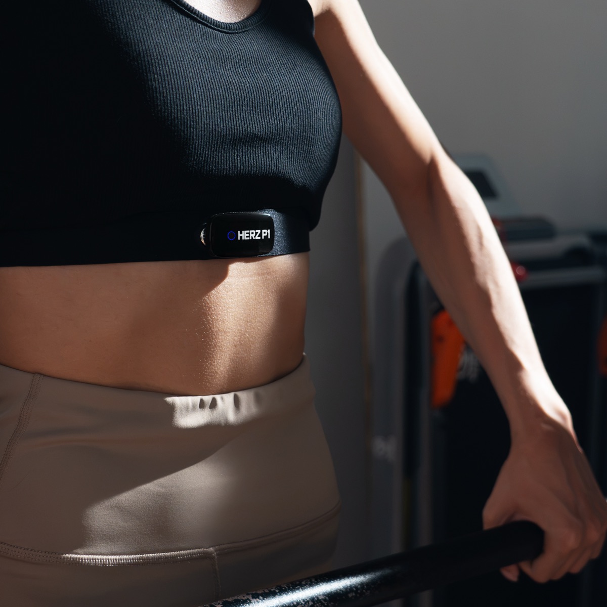 Woman wearing the Herz P1 heart rate chest strap during a workout