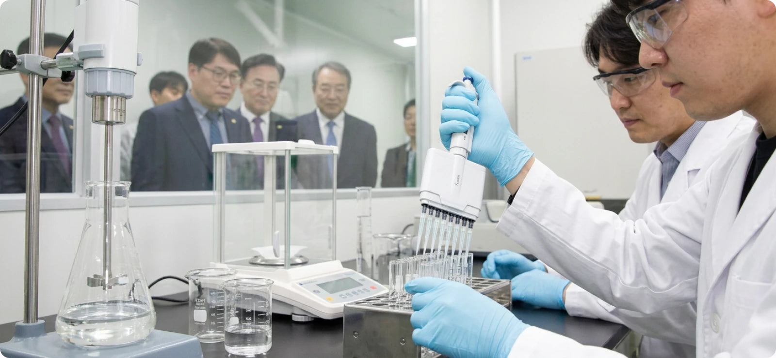 Researchers working with pipettes in a Korean laboratory