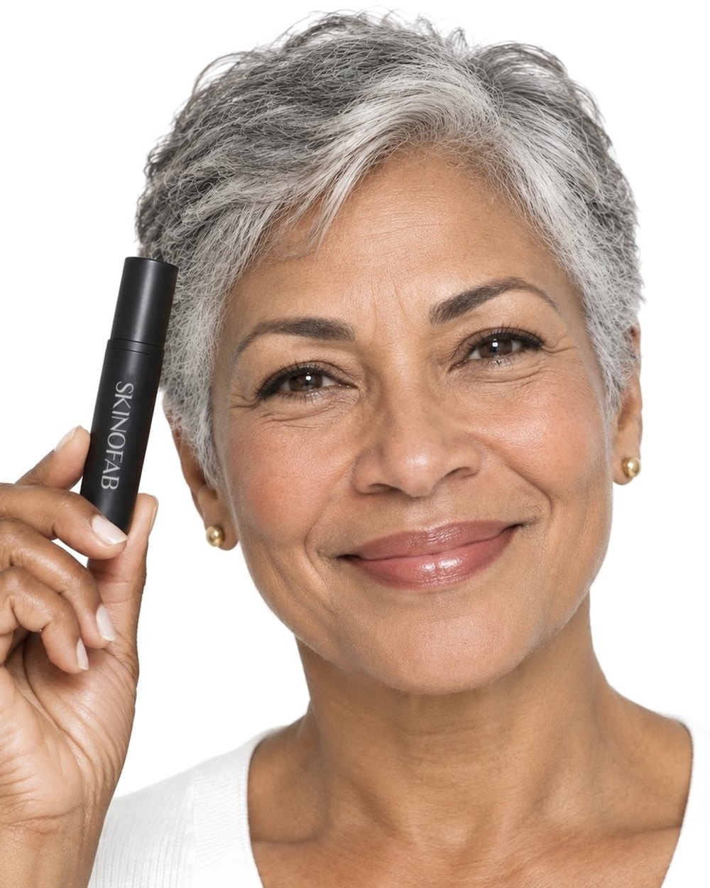 A woman in her sixties holding the Adaptive Foundation Stick by her temple