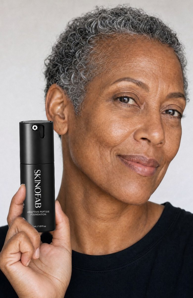 A woman with short grey hair holding the Adaptive Peptide Foundation