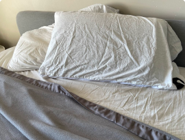 Grounding sheet folded on a bed