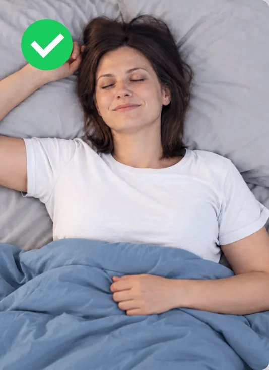 Woman sleeping peacefully on fresh Velin sheets