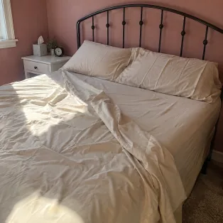 Bed made with beige Velin Silver Thread sheets