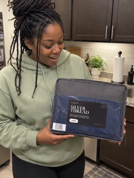 Customer holding her Velin Silver Thread sheet set