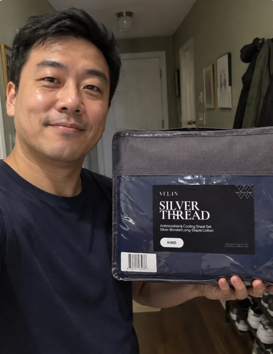 Wesley holding his Velin Silver Thread sheet set