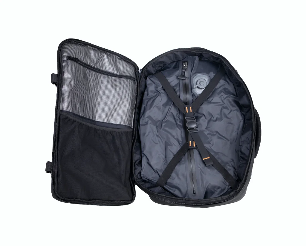 The Voyge Backpack opened flat, showing the compression compartment and organiser pockets