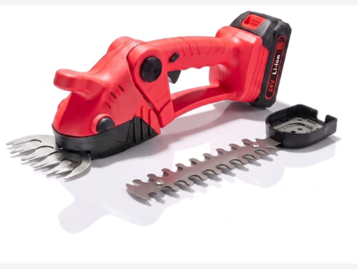 The WOODRANGER Power Hedge Trimmer with both blades and the guard laid out beside it