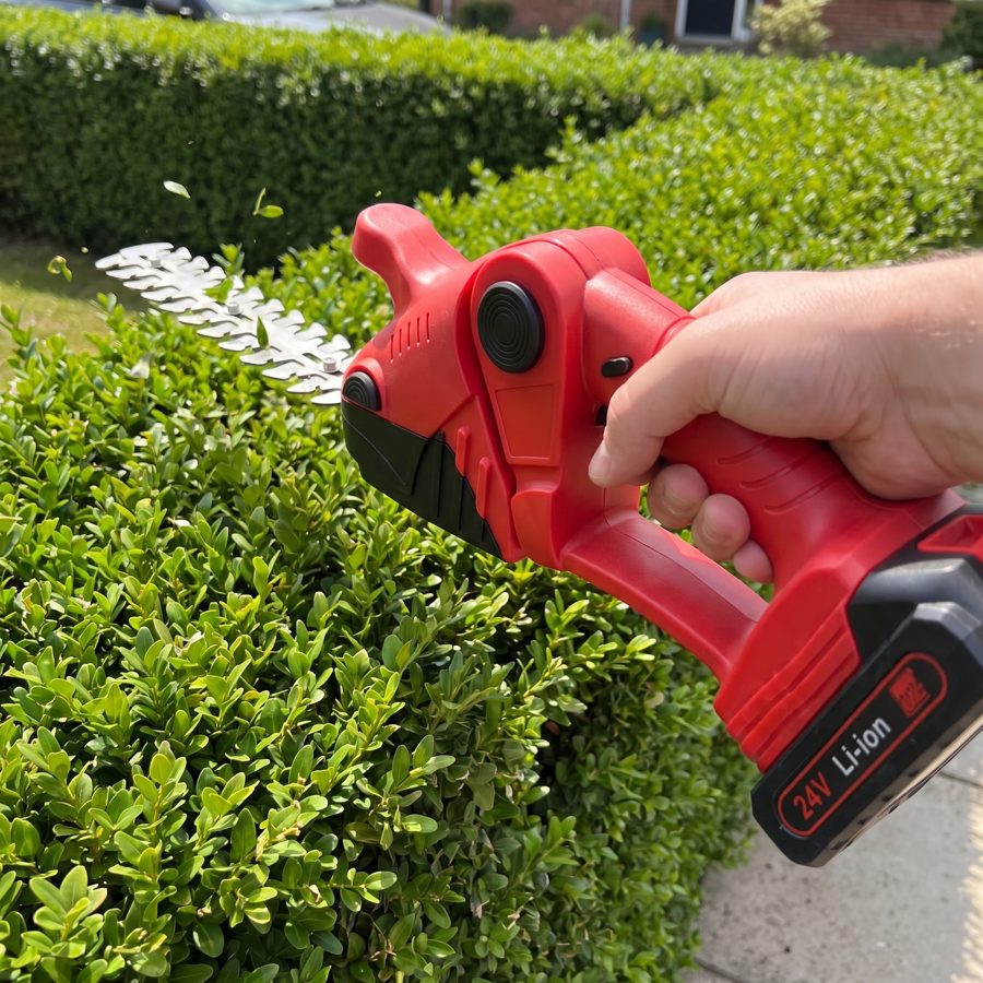 Trimming a garden hedge with the WOODRANGER Power Hedge Trimmer