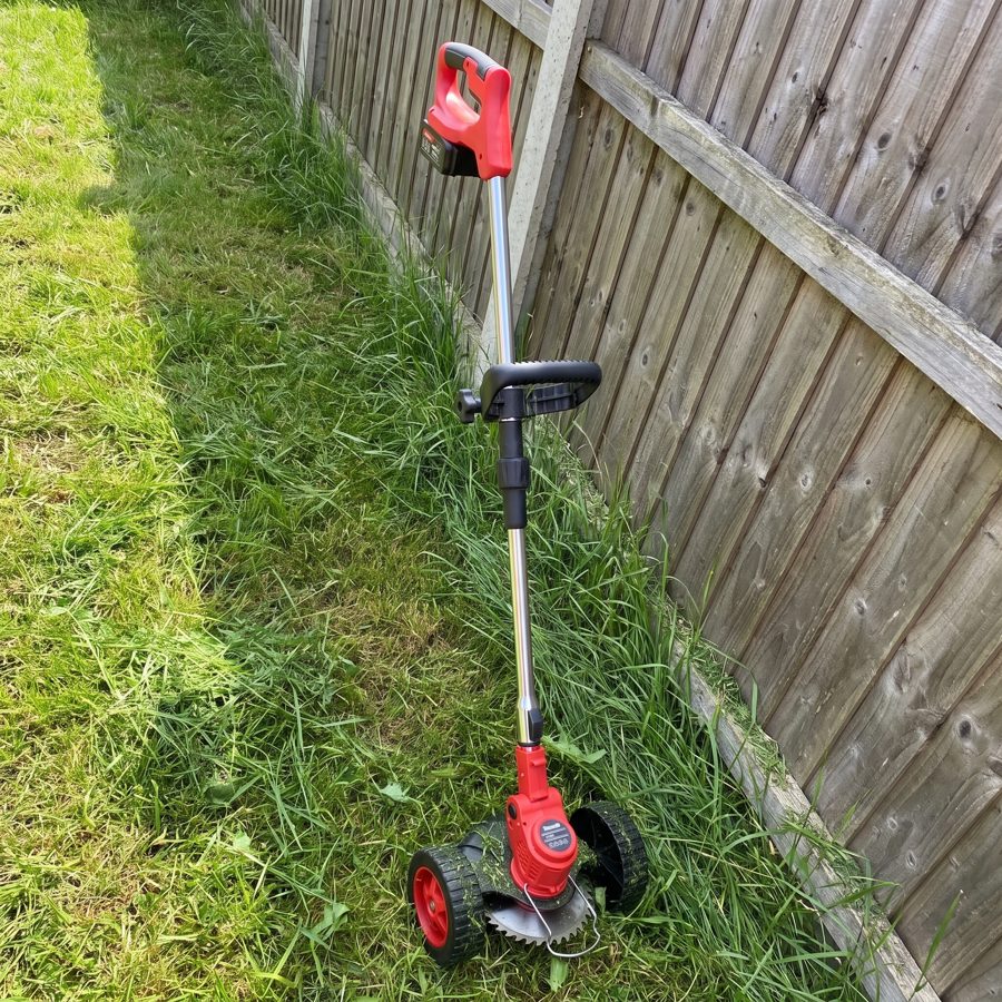 The WOODRANGER Weed & Lawn Trimmer clearing thick weeds