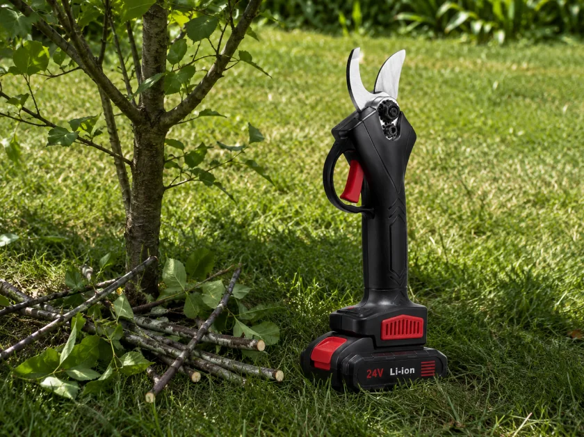 WOODRANGER power shears resting on a trimmed hedge