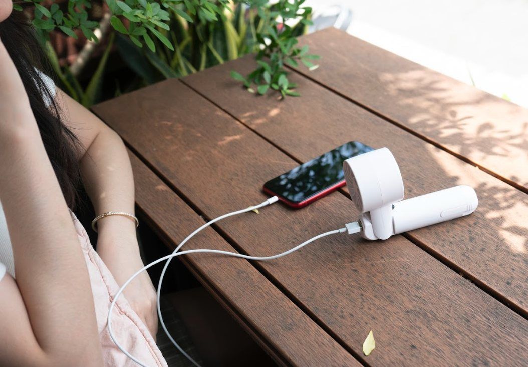 IceForce charging from a phone on a bench