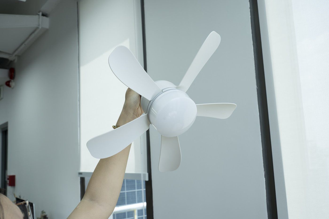 Holding the socket fan up to a light