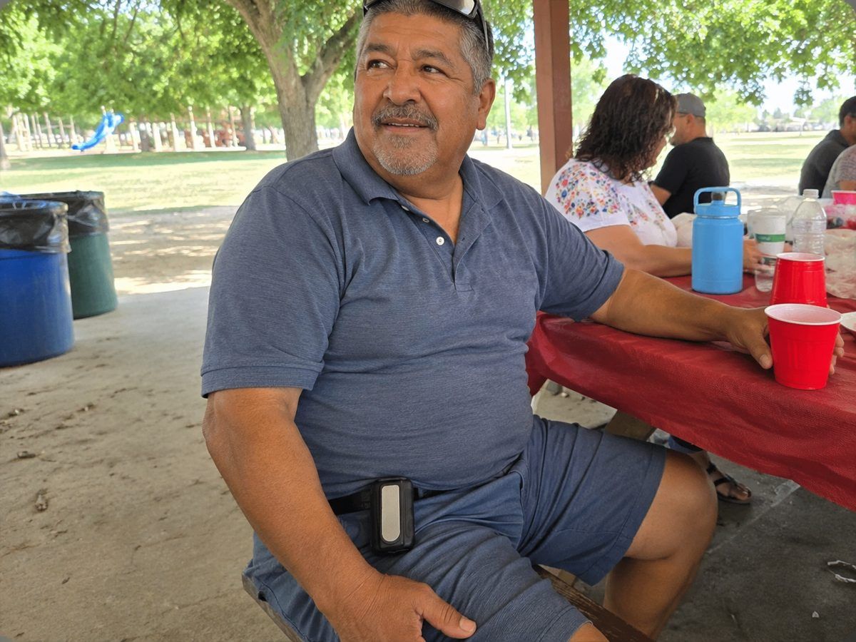 Man at a park picnic table with the Arctic Clip on his belt